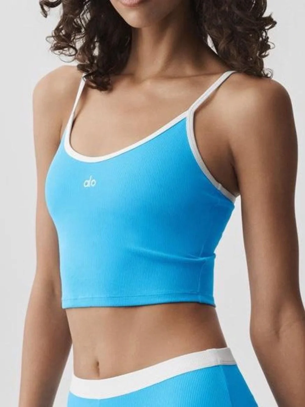 ALO Yoga Goddess Ribbed First Pick Bra Tank in Azure Blue with White Trim.